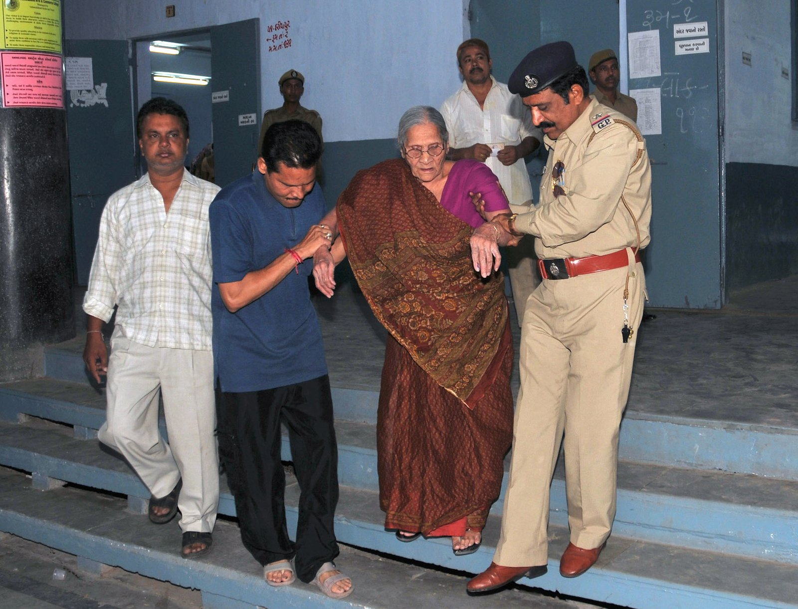 Older resident being assisted outside a polling station in Ahmedabad, Gujarat