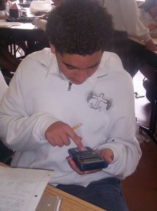 Student using a calculator while studying