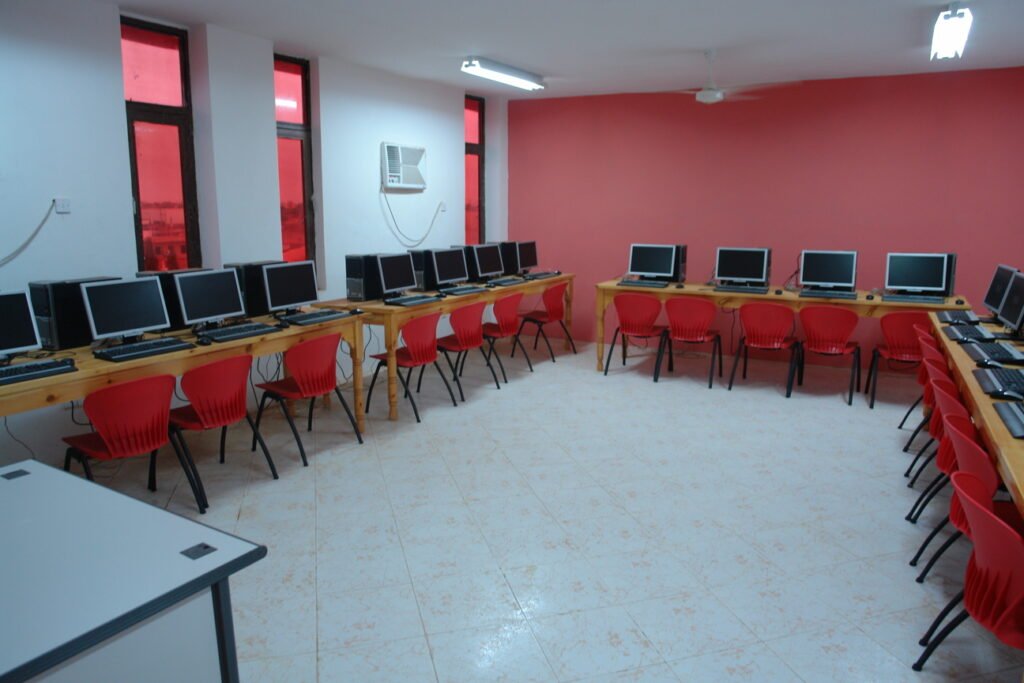 Students working at desktop computers in a university computer lab