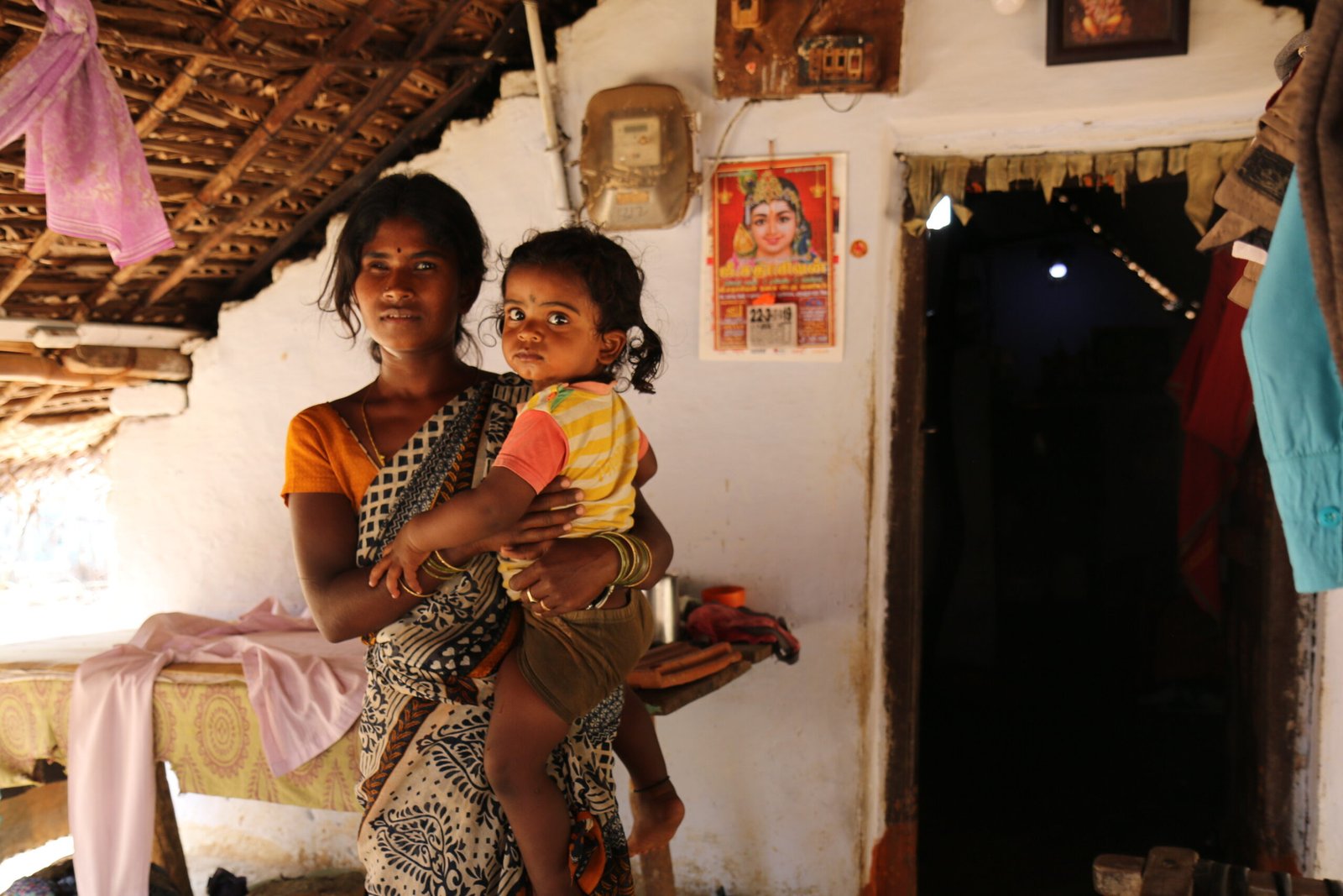 Indian mother holding a child at home, illustrating family-based care