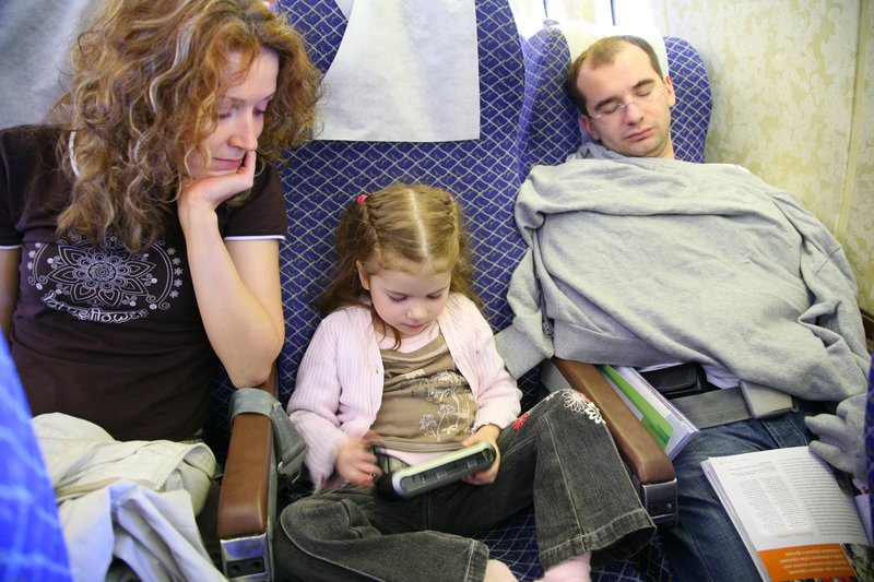 Family travelling through an airport with a child before a flight