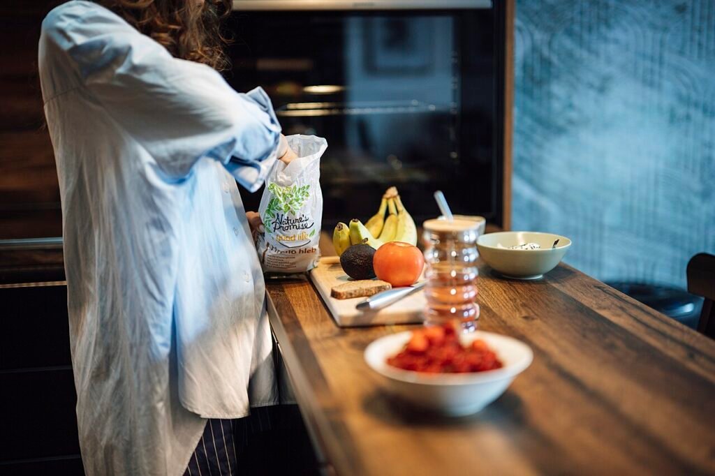 Person preparing food with ingredients on a kitchen table