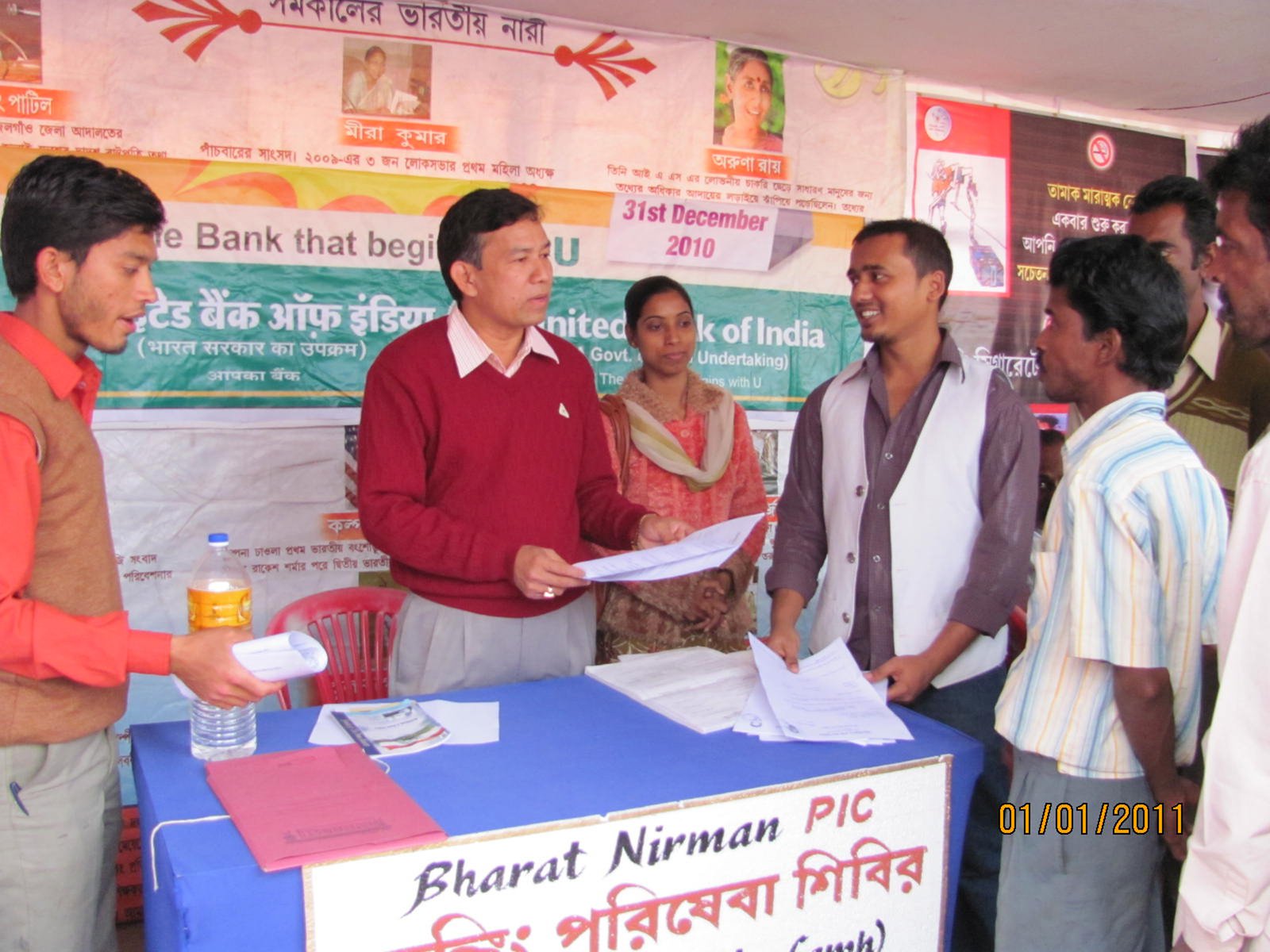Banking officials serving customers at a financial inclusion camp in India