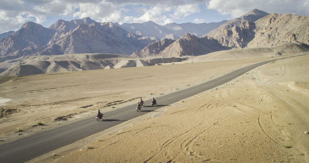Motorcyclists riding on a road in Ladakh, India