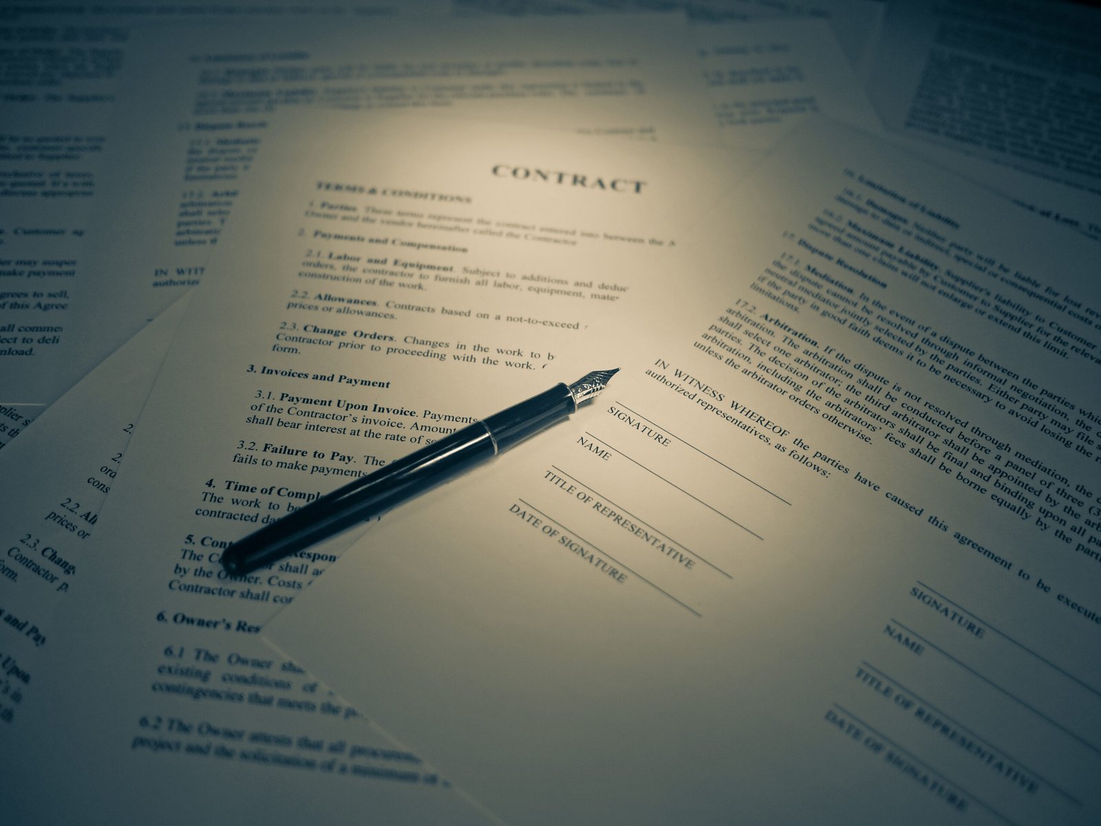 Pen resting on a legal document ready for a signature