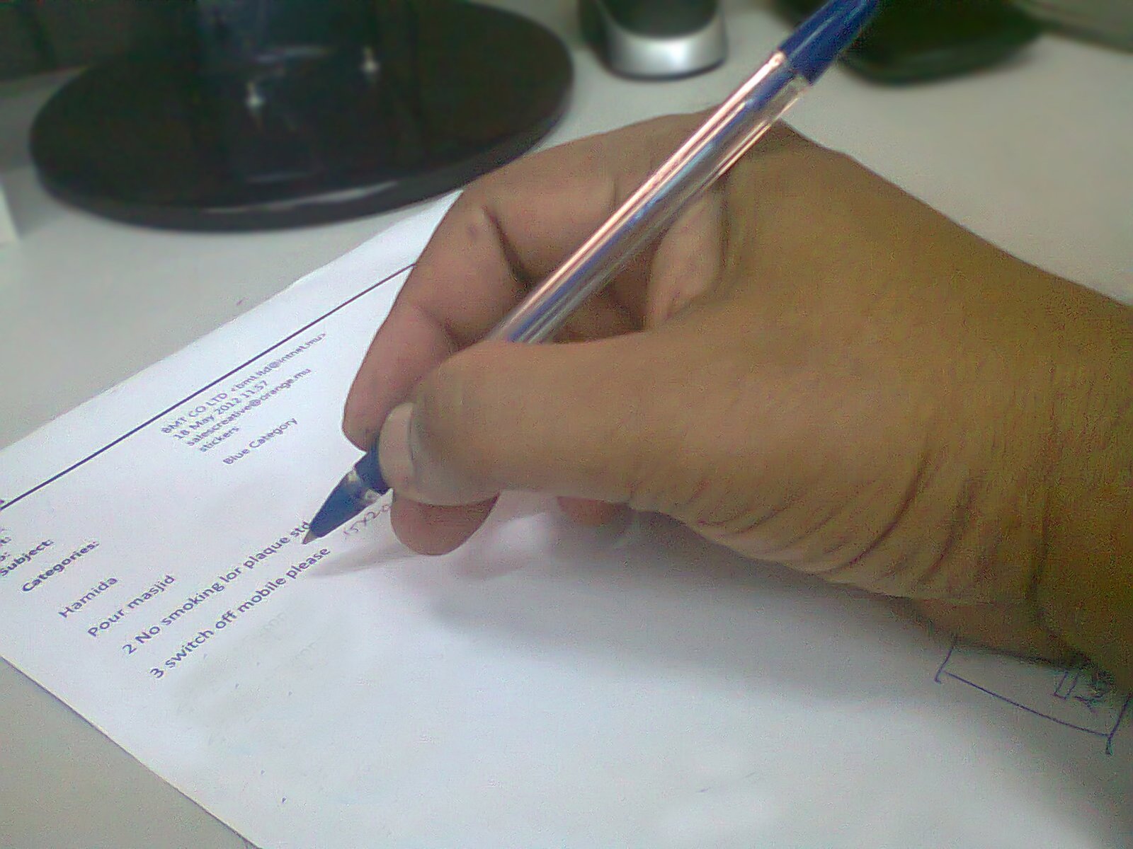 Hand writing on a paper with a pen, representing preparation of a will