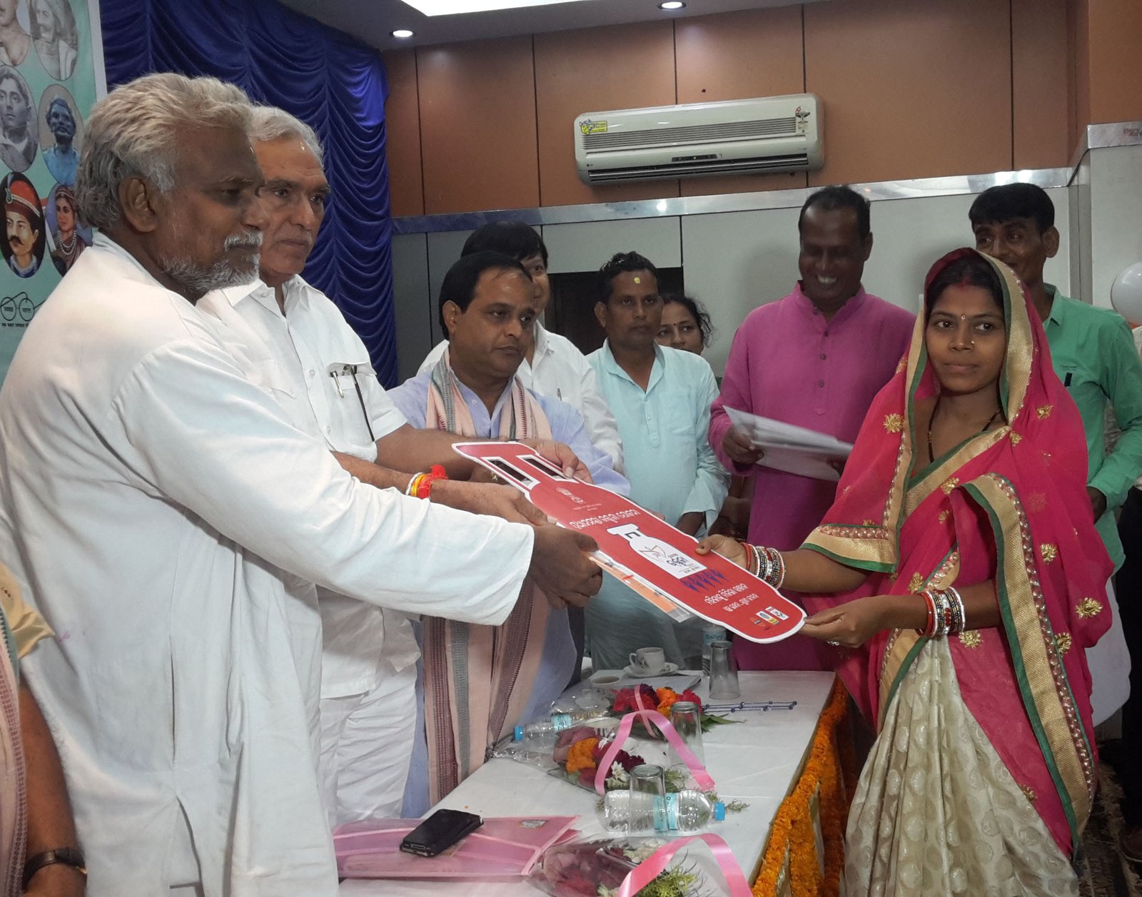 PM Ujjwala Yojana LPG connection being distributed to a woman beneficiary