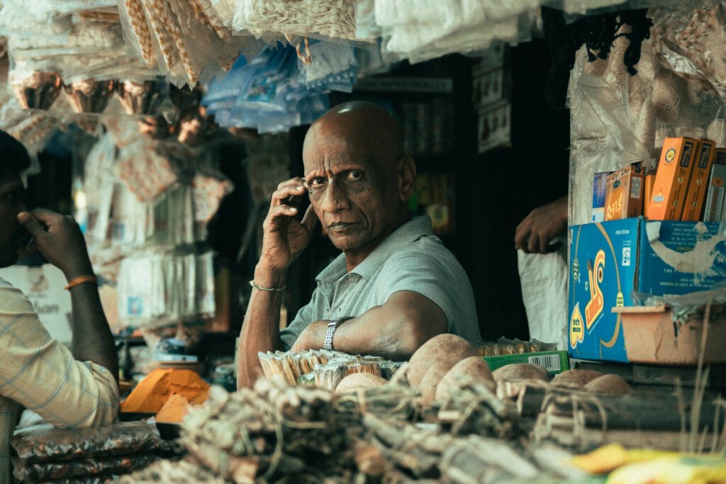 Indian shopkeeper at a busy general store market