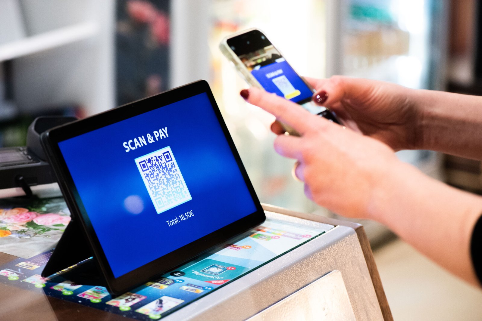 Person using a smartphone to scan a QR code for a digital payment