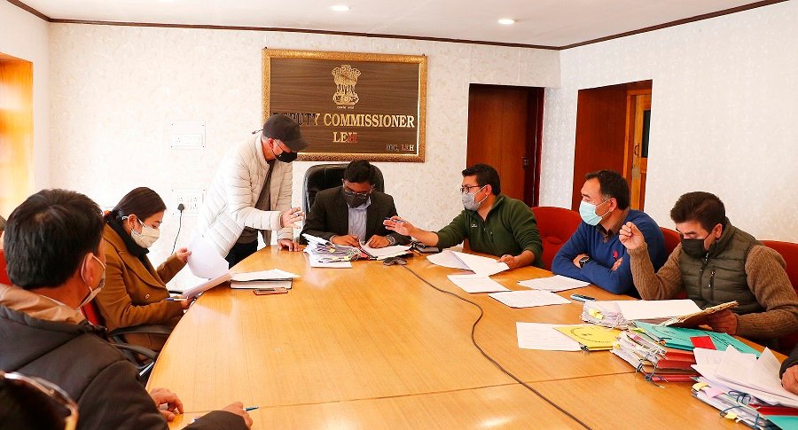 Officials reviewing documents during a government meeting in Leh, Ladakh