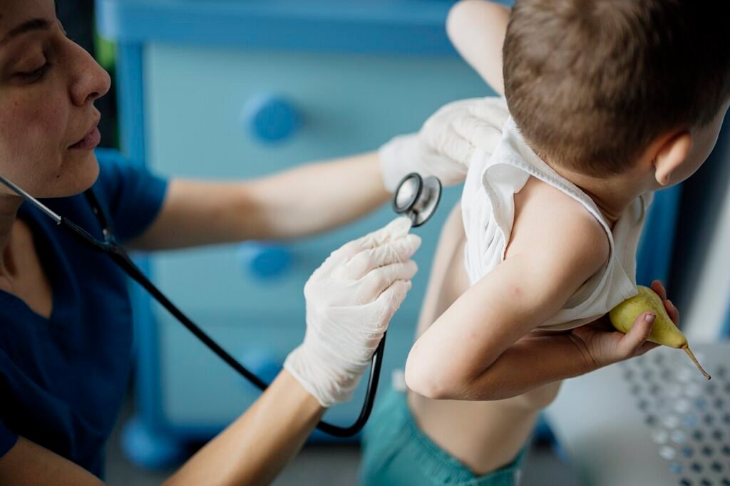 Doctor examining a child during a paediatric checkup