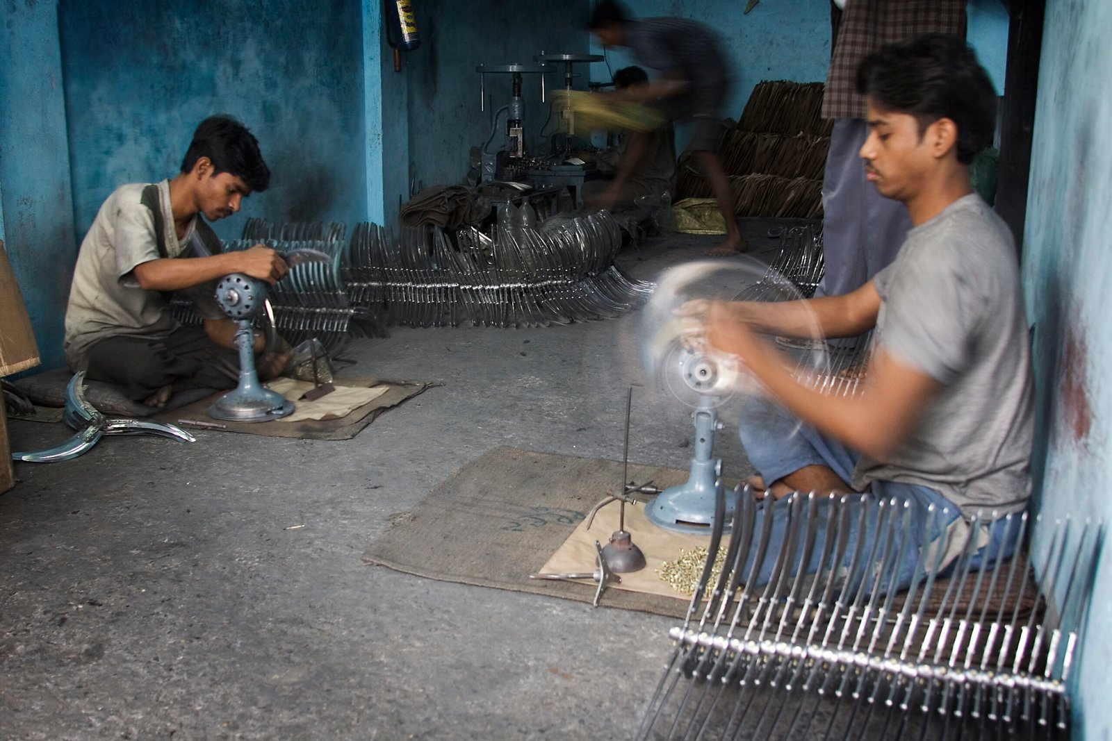 Workers in a Varanasi electric fan factory, used as a representative workplace image