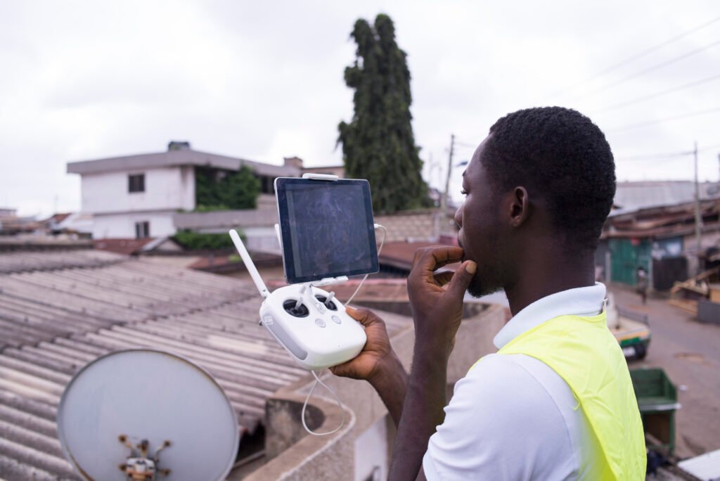 Drone pilot holding a remote controller outdoors