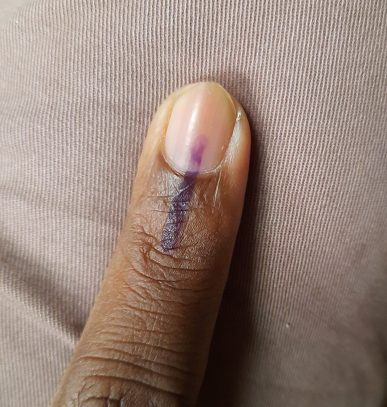 Index finger marked with indelible ink after voting in an Indian election